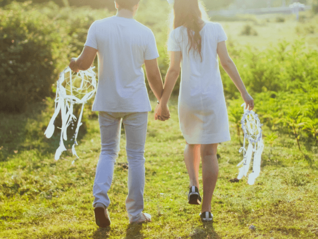 Couple with vegan shoes walking in grass field