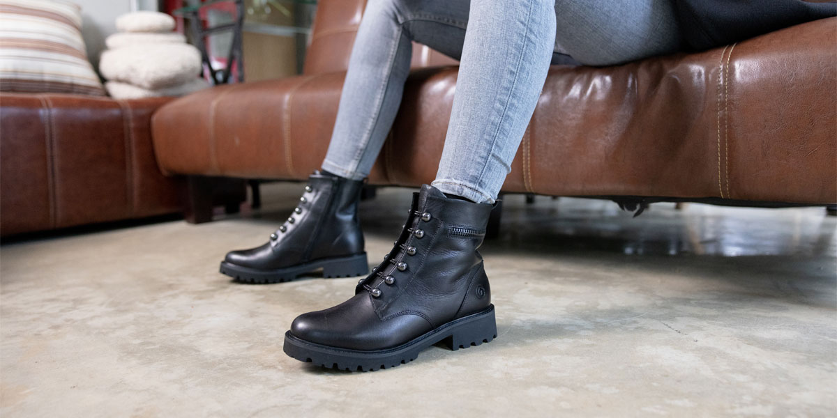 Best Combat Boots Header Image: Sitting woman wearing black combat boots